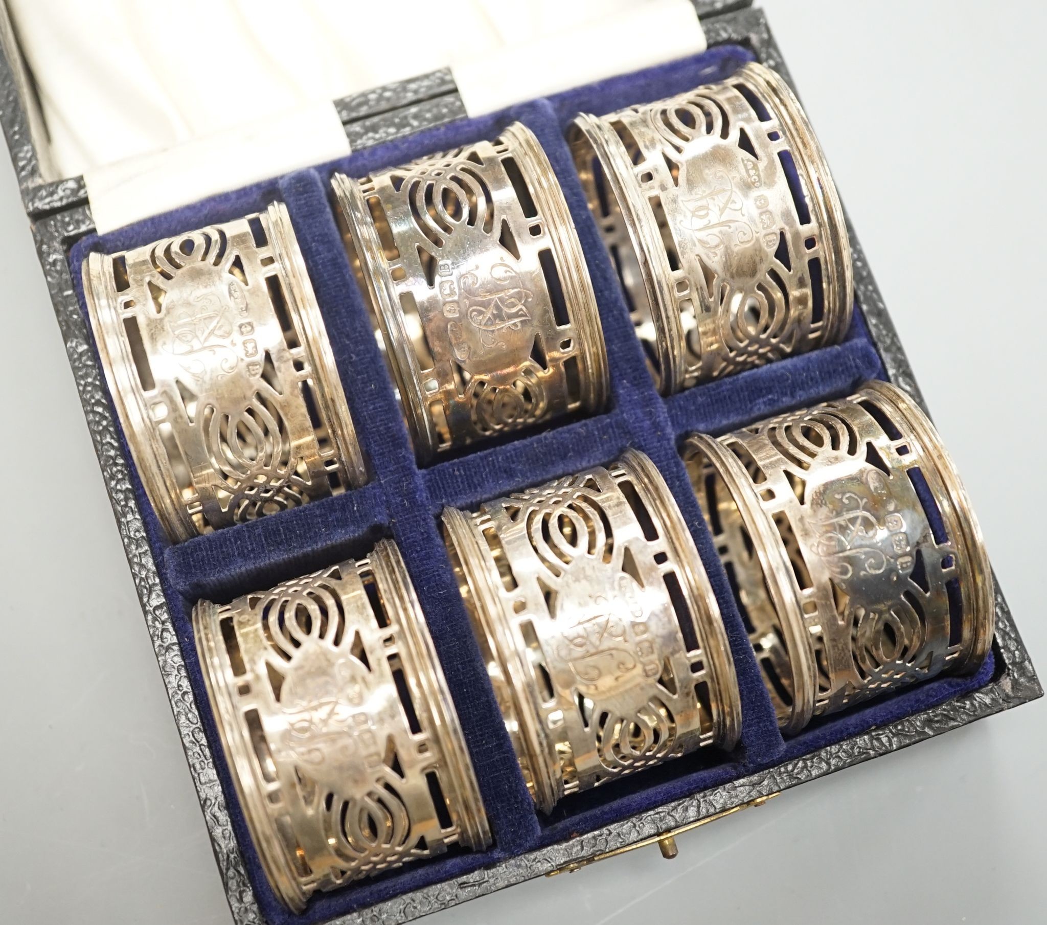 A cased set of six George V pierced silver napkin rings, Birmingham, 1926.